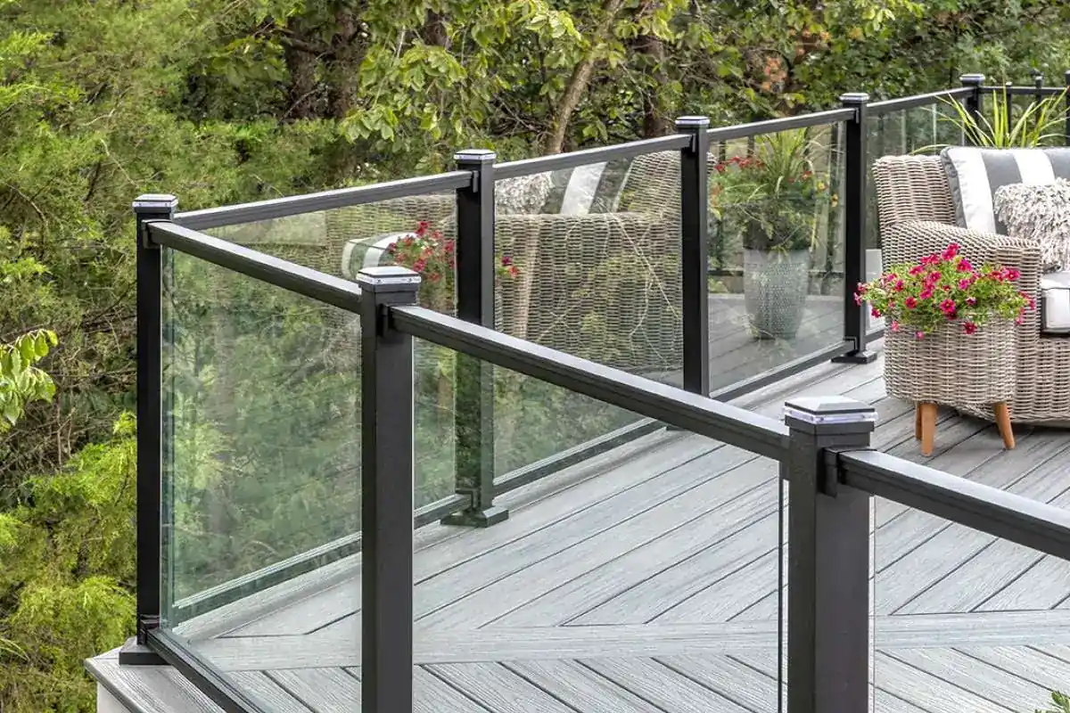 Black aluminum-framed glass railing with square posts on a composite deck
