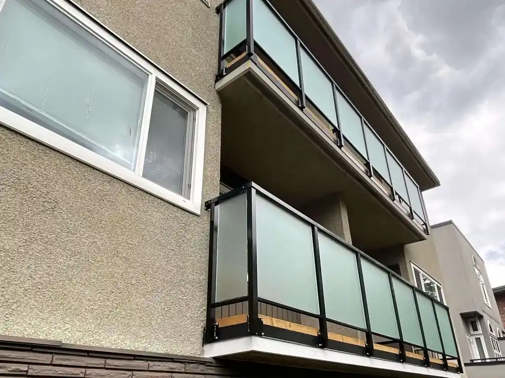 Aluminum-framed glass railings on stacked balconies of a Greater Vancouver home