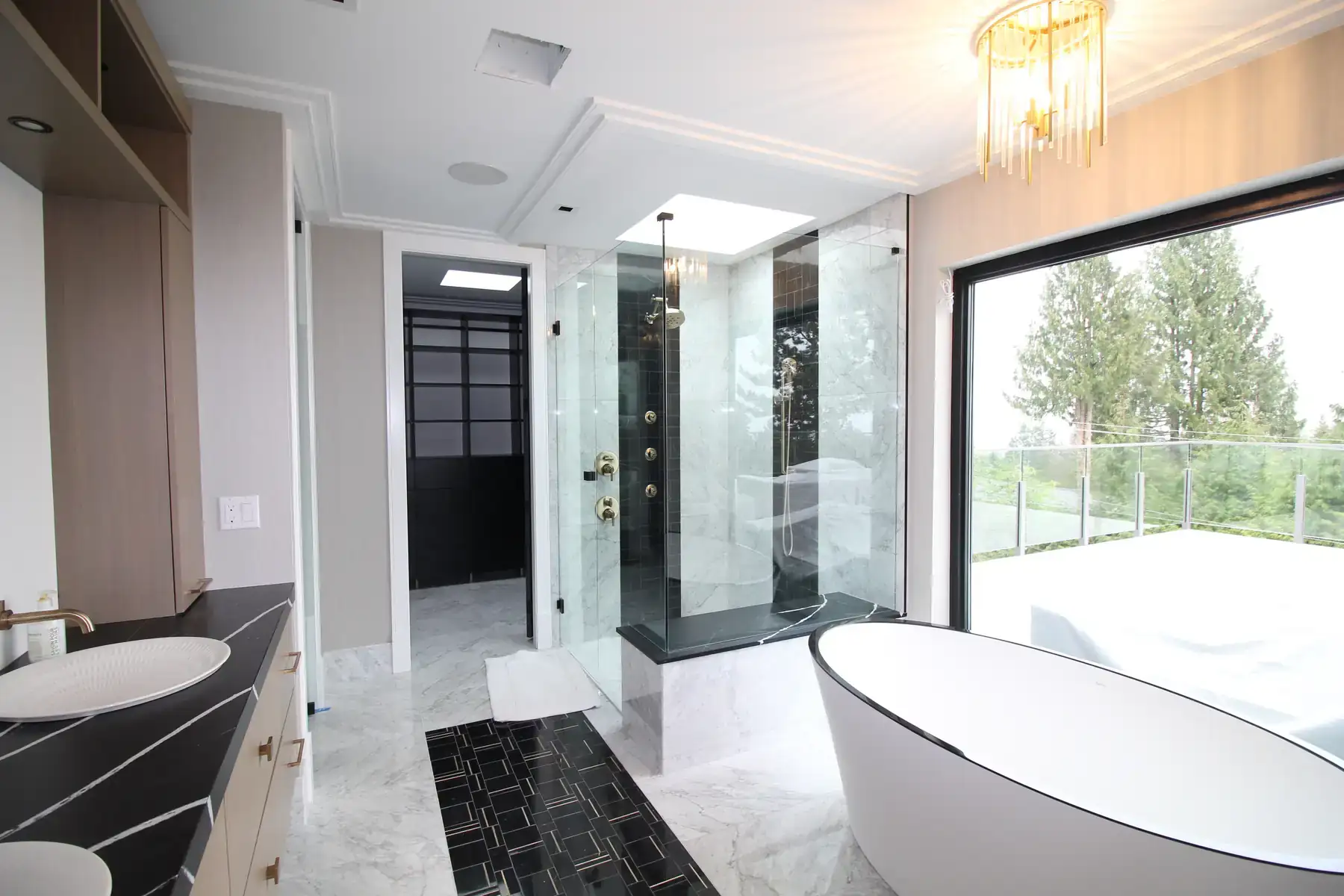 Frameless glass shower enclosure with freestanding tub, installed by Alpha Glass Ltd