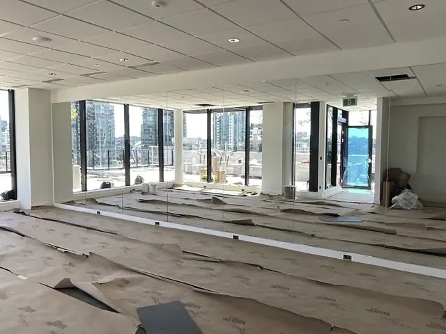 Wall-to-wall gym mirrors in the amenity room at 220 Prior Street