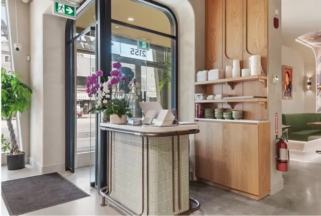 Black-framed glass entrance vestibule with arched doors at Pho Anh Vu