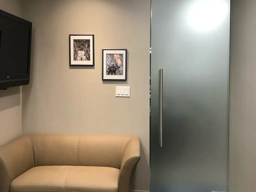 Frameless glass office door with smart film switched to opaque